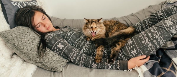 girl sleeping with cat on her lap
